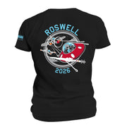 Roswell 2026 black T-shirt featuring an alien flying a red UFO surrounded by vintage fighter planes.